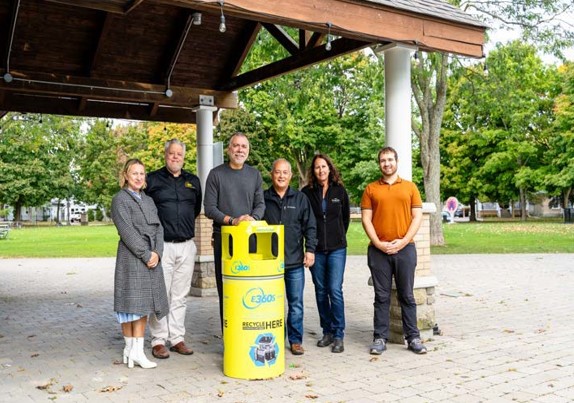 Leaders from Environmental 360 Solutions and Town of Aurora posing behind a battery bin