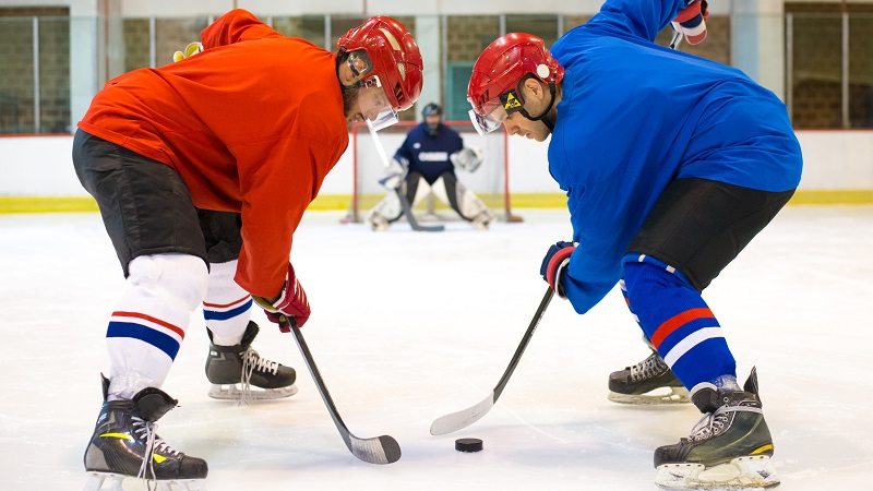 Adults playing shinny hockey on ice