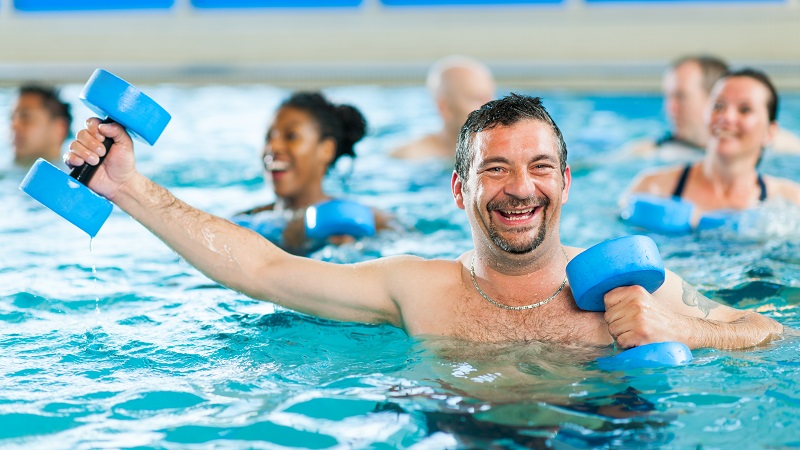 Adults in pool participating in aquafitness class