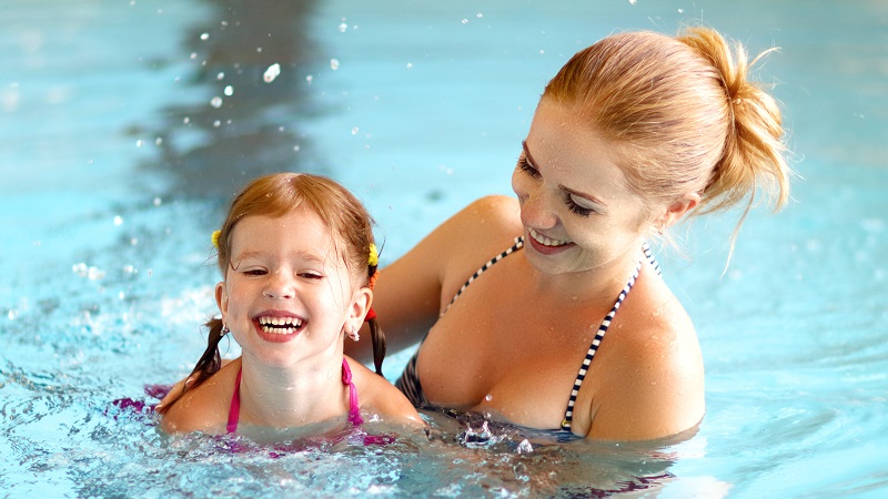 Mom and daughter in swimming pool