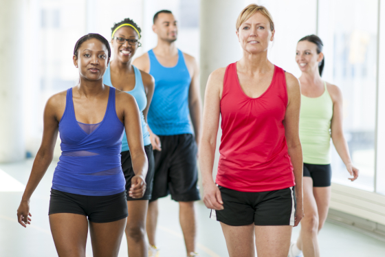 Five people walking on indoor fitness track