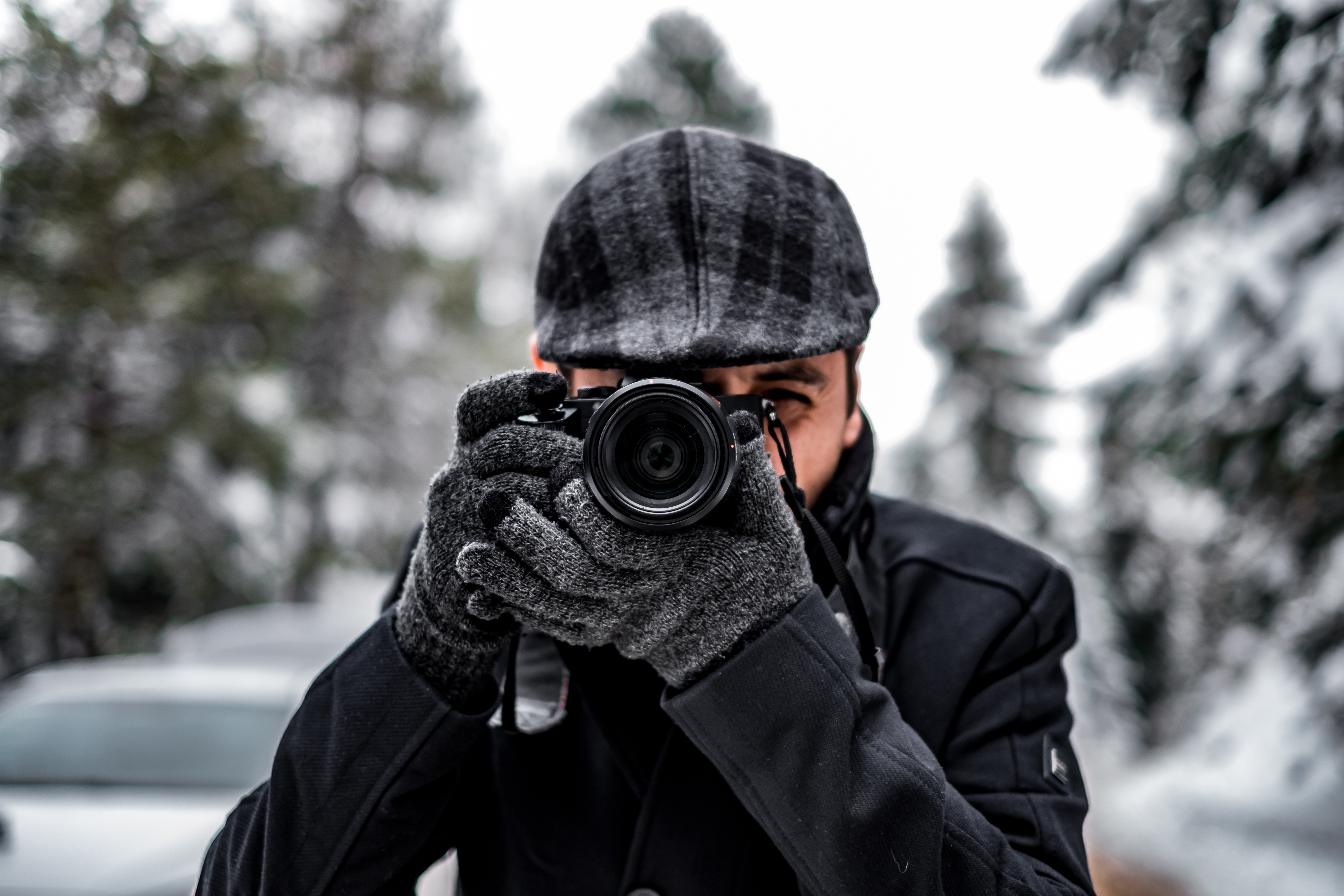 Man holding camera taking photos in the winter