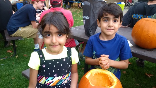 Two kids at concert carving pumpkins