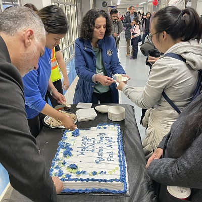 Mayor and residents eating event cake