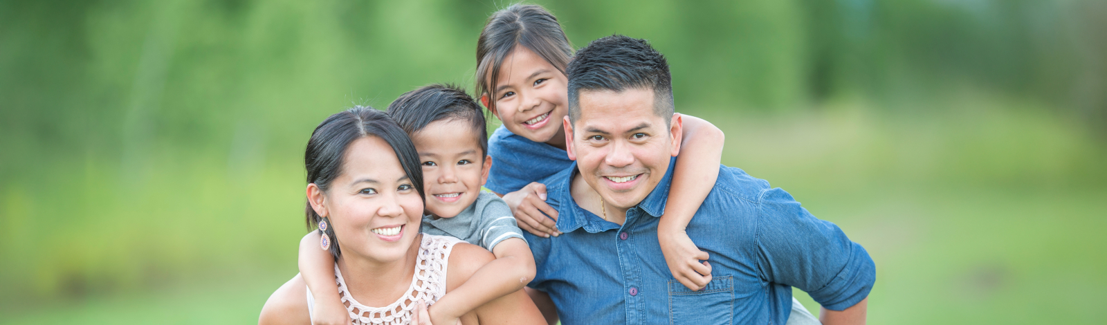 Family of four outdoors summer happy smiling