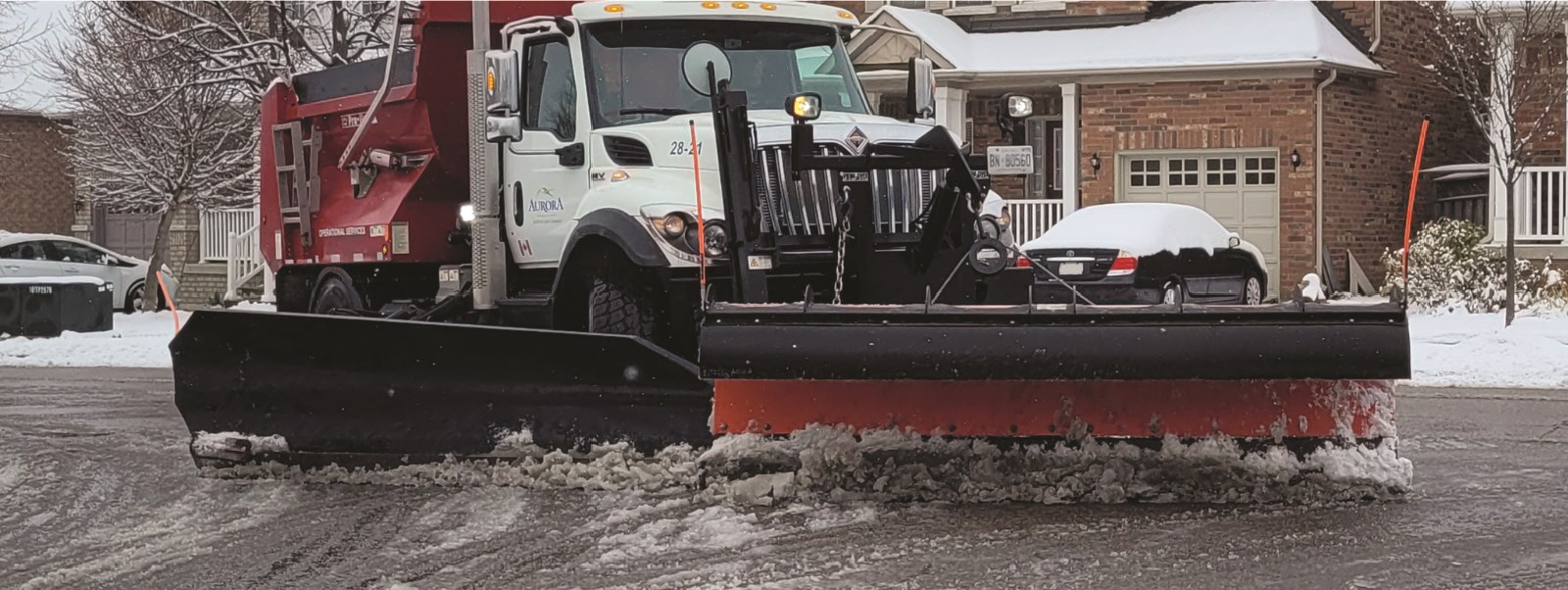 Snow plow removing snow from the roads