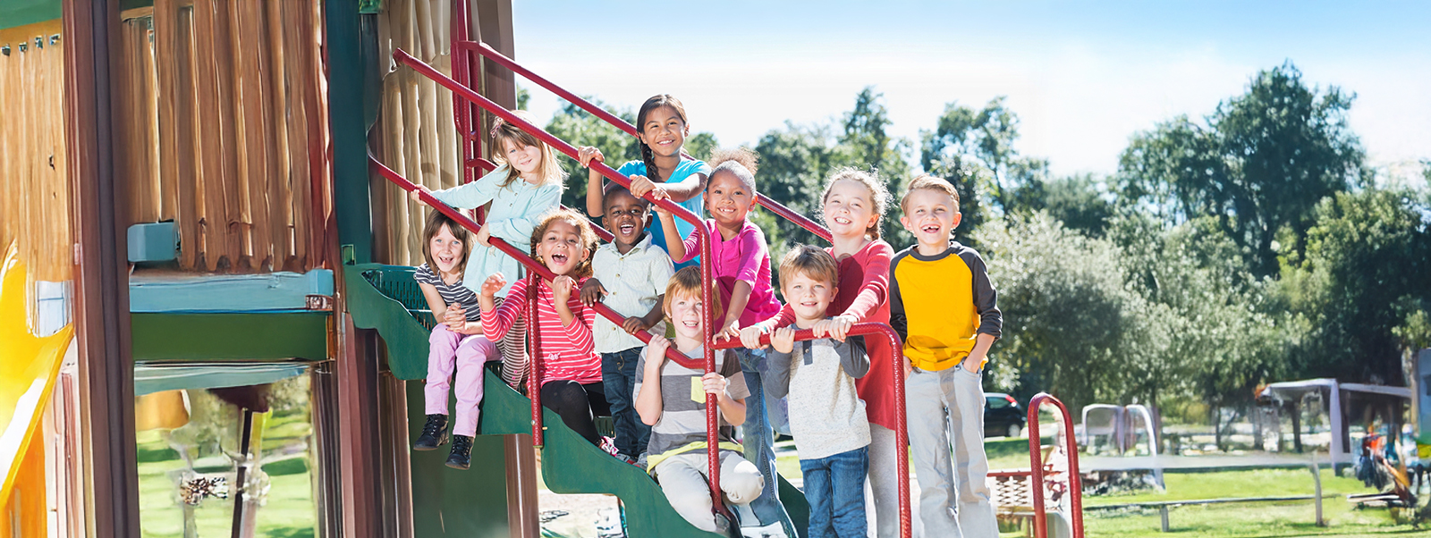 Group of kids posing on a play structure in a playground