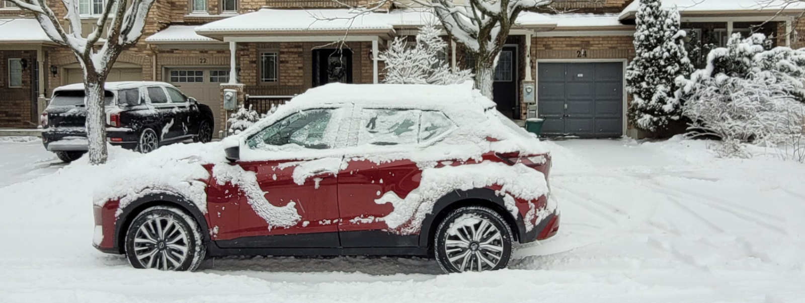 Image of red car parking on road with snow