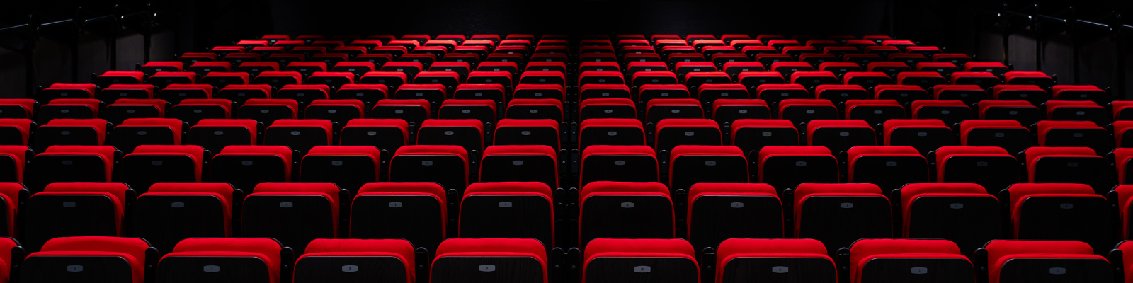 Rows of red seats in the Davide de Simone Performance Hall