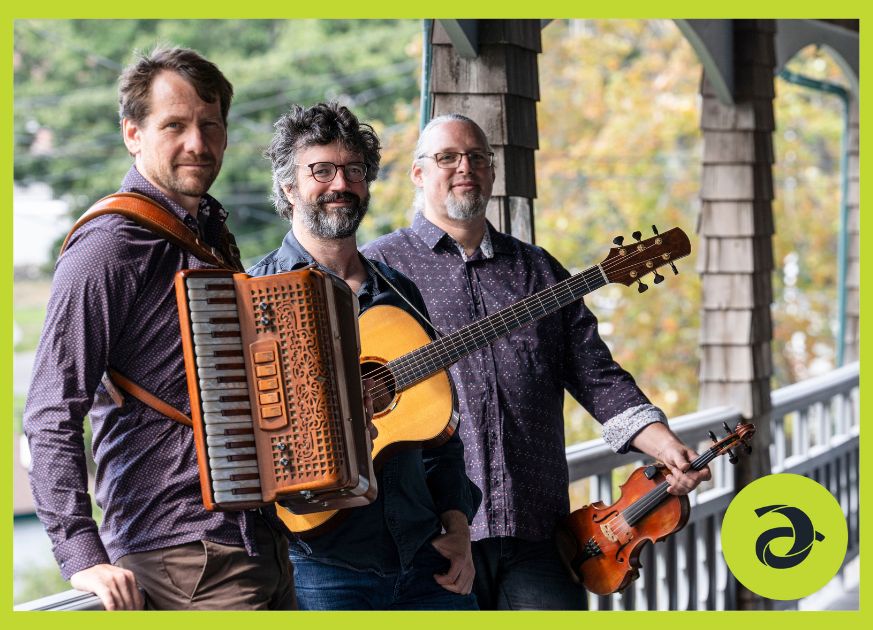 Three men and their instruments sit outside