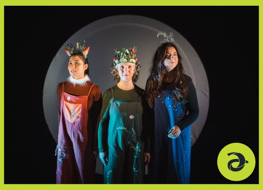 Three women dressed up like the moon and a fox smile for the camera