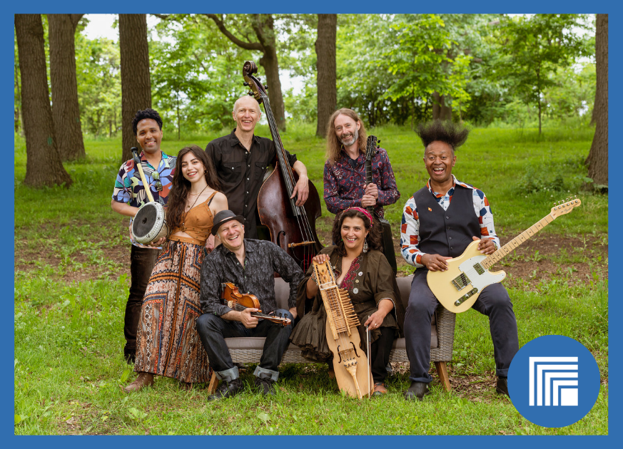 7 musicians sitting outside holding their instruments