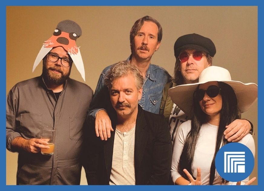 5 Musicians Posing for the camera against a beige background