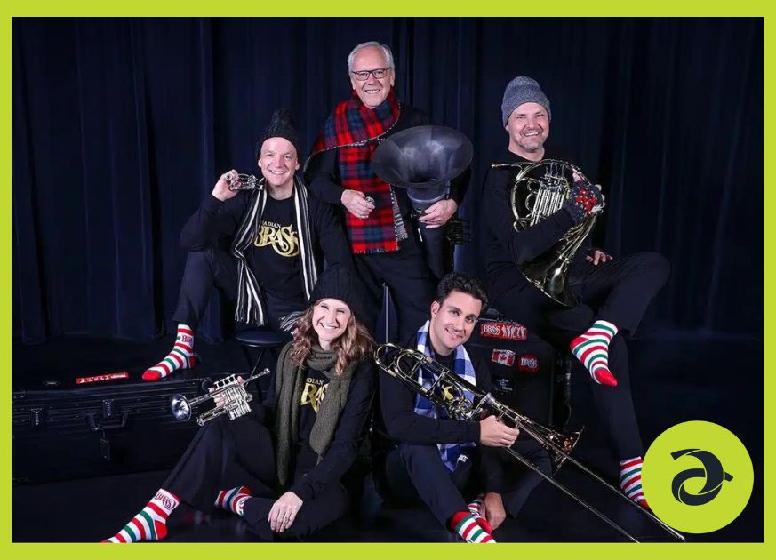 Canadian Brass band, huddles together on a stage with a dark background