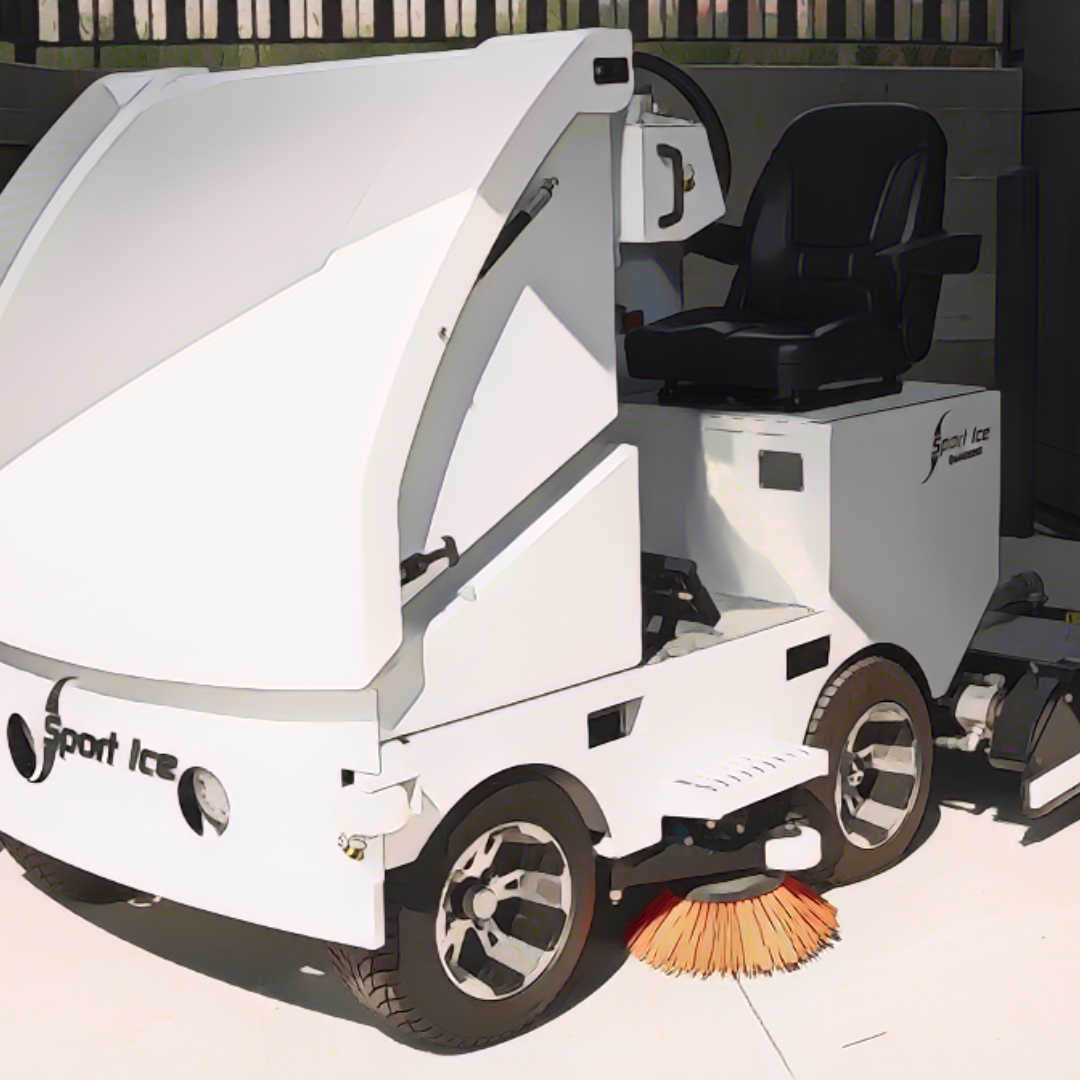 Tiny ice resurfacer parked in a maintenance garage