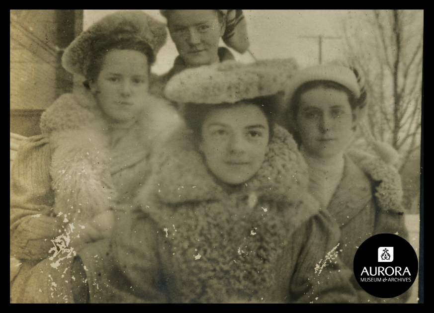 Archival photo of 4 people looking at the camera in winter gear