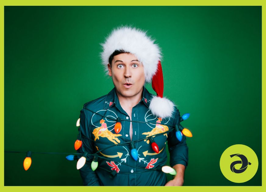 Steven Taetz headshot, wearing a Santa hat with a green background