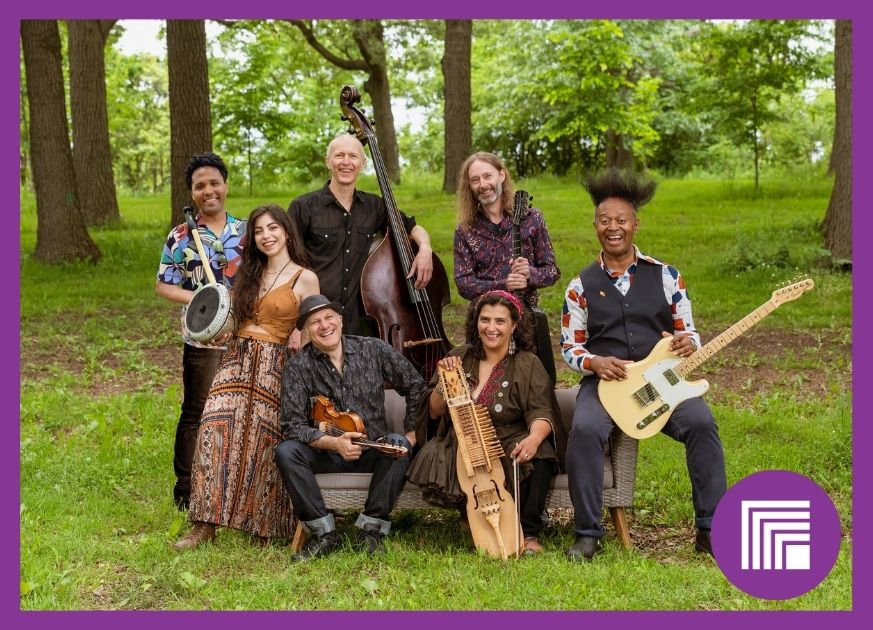 Sultans of String band members, holding their instruments