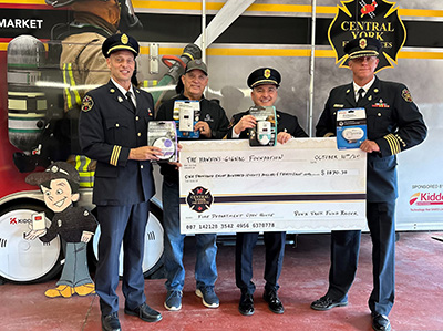 Central York Fire Services employees holding up a very large cheque